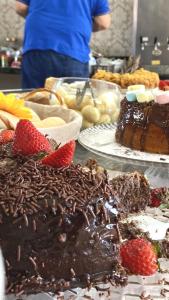 a table with chocolate cake and strawberries and other desserts at Hotel Costa Dalpiaz in Torres