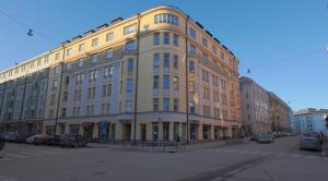 a large building on a city street with cars parked at Stylish studio in the centre in Helsinki