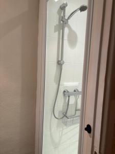 a shower in a bathroom with a shower head at Hideway Dartmouth in Dartmouth +5 photos