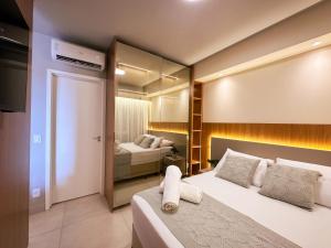 a hotel room with a bed and a bedroom at Ribeirão Premium Apogeo in Ribeirão Preto +54 photos