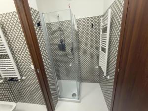 a bathroom with a shower with a glass door at Colle Muzia B&B e Affittacamere in Muccia +82 photos