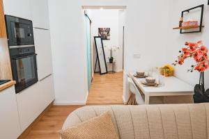 a living room with a couch and a table at Tímár 18 Apartman in Pécs