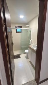 a bathroom with a shower and a toilet and a sink at Bangalô com Quarto, Sala, Varanda in Maceió