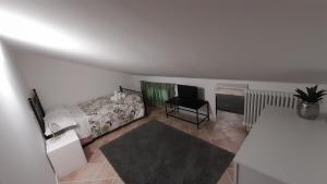 a bedroom with a bed and a desk and a television at Sotto i Lucernai in Cagli +6 photos