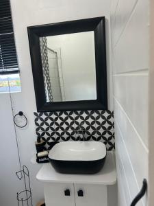 a bathroom with a sink and a mirror at Private big Apartment in Eversdal +2 photos