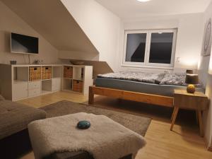 a bedroom with a bed and a large window at Kleine Auszeit Eifel mit Dachterrasse in Nettersheim
