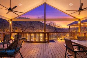 a deck with chairs and a table with a view at River Road Villas #2 in New Braunfels