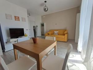 a living room with a table and chairs and a couch at Il Nido di Chiara 2 in Formia