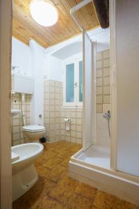 a bathroom with a shower and a toilet and a sink at CaTorre 14 in Riomaggiore