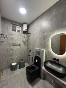 a bathroom with a black sink and a mirror at Vrs Homestay in Mayiladuthurai