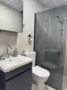 a bathroom with a shower and a toilet and a sink at New Yasamkent Atakoru Double Suite in Alacaatlı
