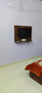 a flat screen tv on a wall in a room at Hotel Shree palace in Jabalpur