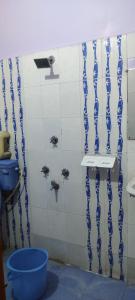 a bathroom with blue and white stripes on the wall at Hotel Shree palace in Jabalpur +7 photos
