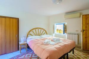 a bedroom with a bed with a dog laying on it at CaTorre 14 in Riomaggiore