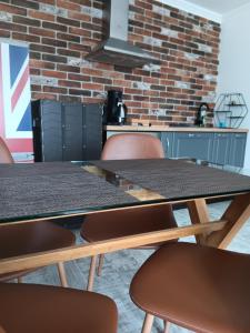 a room with two tables and chairs and a brick wall at Dido House Panoramic -Eurovision Fans Hub 2027 in Veliko Tŭrnovo