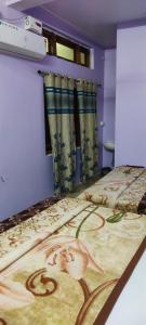 a bedroom with a bed with a painting on it at Hotel Shree palace in Jabalpur