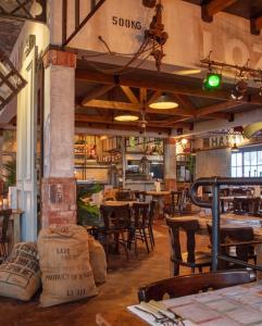 a restaurant with tables and chairs in a room at Hotel Loco in Lievelde