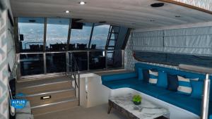 a balcony of a boat with a blue couch at vip motoryat in Alanya