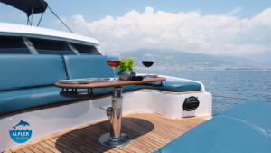 a table on the back of a boat with two glasses of wine at vip motoryat in Alanya