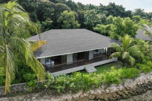 an aerial view of a house with a roof at Riahi Villas by Swiss-Belhotel, Nirup Island in Belakangpandang