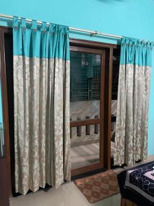 a window with curtains in a room with a balcony at Abode of Peace in Esperance