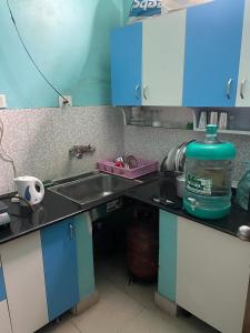 a kitchen counter with a sink and a large bottle of water at Abode of Peace in Esperance
