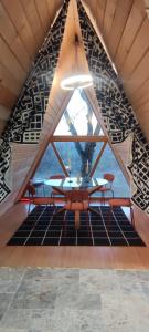 a dining room with a table and a large window at Escaper at Nereju Star Place in Carşocheşti