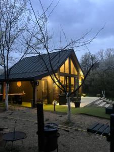 a house with a gambrel roof on top of it at Arbor in Vadu Crişului
