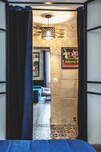 a view of a living room with a blue curtain at Le charmant, Hyper Centre Angers in Angers +4 photos