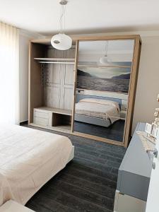a bedroom with a bed and a large mirror at Playadeivo in Pineto