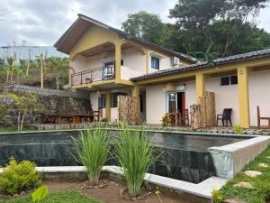 a house with a swimming pool in front of it at Villa Baby lodge in Hell-Ville