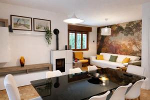 a living room with a couch and a table and chairs at Villa Riviera by the Sea in Lignano Sabbiadoro