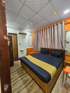 a bedroom with a large bed in a room at hotel orange palace in Surat