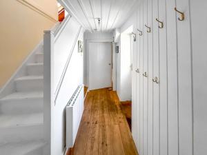 a hallway of a house with white walls and wooden floors at Rosscot in Ankerville