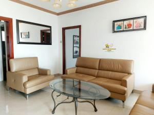 a living room with a couch and a glass table at Samfya waterfront lodge 
