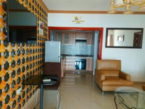 a kitchen with a couch and a table and a refrigerator at Samfya waterfront lodge 