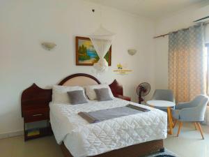 a bedroom with a bed and a table and chairs at Samfya waterfront lodge 