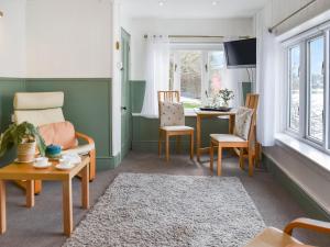 a living room with a table and chairs at Riverside Retreat in Beccles +15 photos