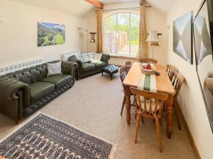 a living room with a table and a couch at Meadow View Broadlea in Stokeham