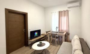 a living room with a couch and a table at Nanchev Apartments in Gevgelija