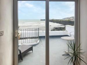 a view of the beach from a room with a window at Hen Joppa in Newlyn +11 photos