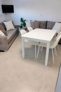 a white table and chairs in a living room with a couch at Sesi Luxury Suites Seaside & Private Pool in Marathon