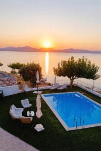 a swimming pool with a view of the ocean at sunset at Sesi Luxury Suites Seaside & Private Pool in Marathon