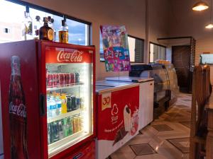 a coca cola refrigerator in a store with drinks at Pousada pôr do sol in Riachuelo