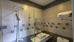 a bathroom with a sink and a shower at Vô Tư Luxury Hotel in Da Lat +29 photos