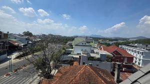 a view of a city with roofs and buildings at Vô Tư Luxury Hotel in Da Lat