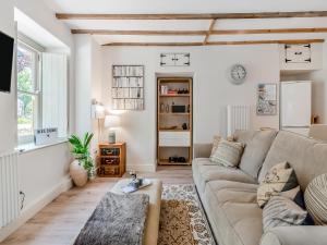a living room with a couch and a table at Dyffryn Glanffrwd Mill in Cellan