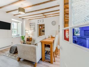a living room with a table and a couch at Dyffryn Glanffrwd Mill in Cellan