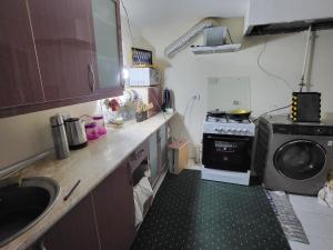 a small kitchen with a sink and a washing machine at Bobo Haydar FREE LONDRY SERVICE in Bukhara