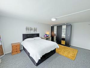 a bedroom with a bed and a desk and a window at Riverside Cottage in Spalding +13 photos